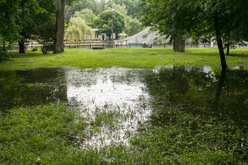 Public park drenched in rain. Water logged park.Wet benches. Park filled with water after...