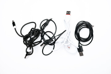 tangled usb wires from the phone on a white background