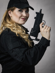 Woman holds gun in hands.