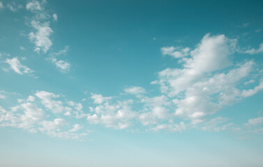 Beautiful blue midday sky with white fluffy clouds