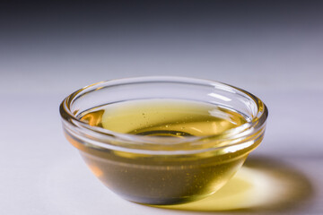 glass bowl with fresh golden liquid honey