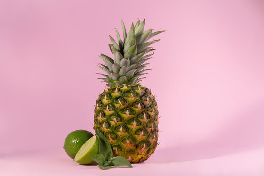 Fresh Ripe Pineapple against a pink background. Hello, Summer concept.