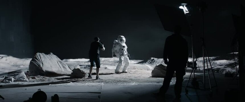 WIDE Behind the scenes, cinematographer shooting viral video for social account on a large Moon landing set. Virtual production with LED screens. Shot with 2x anamorphic lens