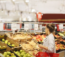 Woman buying fruits and vegetables at the market