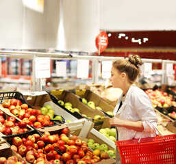 Woman buying fruits and vegetables at the market