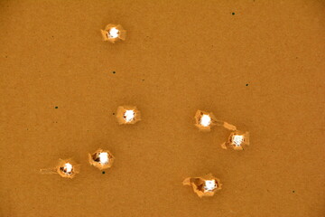 9 mm bullet holes in cardboard.