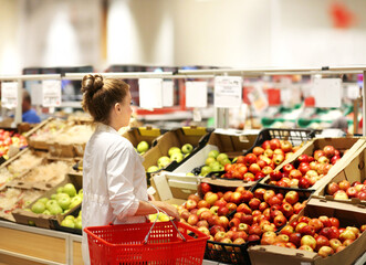 Woman buying fruits and vegetables at the market