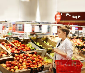 Woman buying fruits and vegetables at the market
