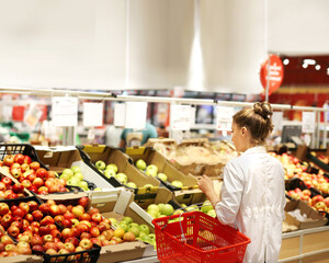 Woman buying fruits and vegetables at the market
