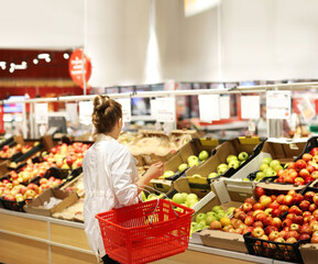 Woman buying fruits and vegetables at the market