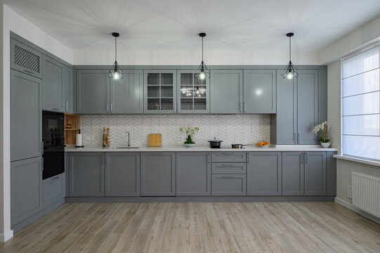 Trendy grey and white modern kitchen furniture, front view