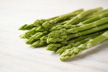Fresh asparagus on wooden background, close-up.