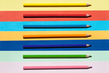 Fototapeta premium Color pencils on colored background. Back to school, arrangement concept.