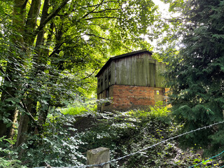 Old building, hidden by old trees, next to a country trail near, Tweedy Lane, Wilsden, UK