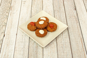 Usual presentation of a portion of falafel with white and red sauce prepared in a  pakistani kebab