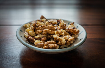 Small bowl of cracked walnuts for snack