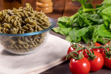 Fototapeta na wymiar Raw spinach screw noodles, vegetarian, vegan . Healthy food