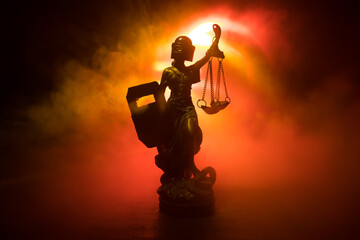 Law concept. Miniature colorful artwork decoration with fog and backlight. The Statue of Justice -...