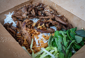 Vietnamese dish Bun Bo Nam Bo in a take out box - beef, noodles, bean sprouts and veggies