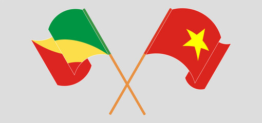 Crossed and waving flags of Republic of the Congo and Vietnam