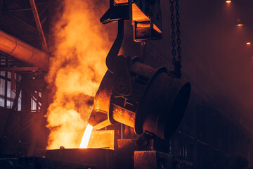 Molten metal casting. Pouring iron with smoke and sparks. Metallurgical plant. Steel production....
