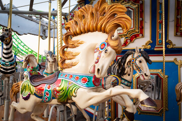 Fototapeta na wymiar Majestic Colorful Horse on carousel in the park