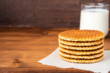 Traditional local authentic Dutch Netherlands sweet fresh homemade tasty stack brown golden waffle melt salted caramel honey syrup for dessert in cafe with hot warm coffee milk tea call Stroopwafel