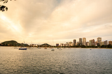 Fototapeta premium Panoramic photo of the city of Vitoria, capital of Espirito Santo State, Brazil. Boats and buildings. Third bridge and the penha convent in the background. Tourist spots