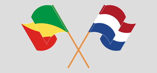 Crossed and waving flags of Republic of the Congo and the Netherlands