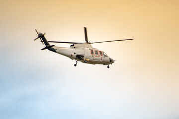 Fototapeta na wymiar Helicopter flying in a beautiful sky