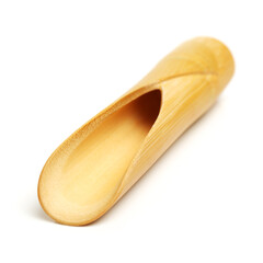 Wooden scoop over dry green tea leaves