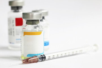 vaccine and syringe on white background with copy space for text