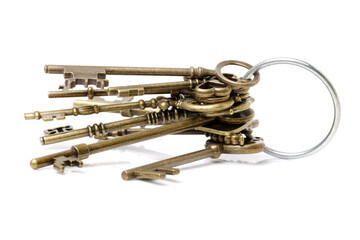 old brass key against a white background