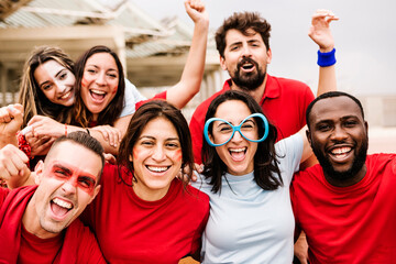 Multiracial group of friends in team colours watching sports live event at stadium - Sport entertainment and championship concept