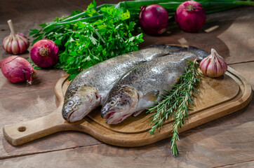 trout on a kitchen board, rustic wooden table. copy space