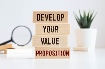 develop your value proposition. text on white paper near financial charts and points