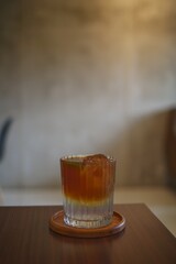 selected focus of iced coffee with soda on a table in a cafe 