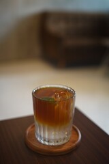 selected focus of iced coffee with soda on a table in a cafe 
