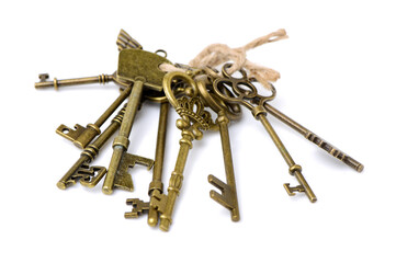 old brass key against a white background