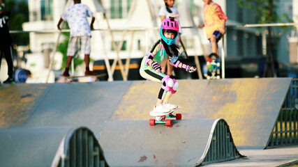 asian girl riding sufe skate or skateboarding on skate park