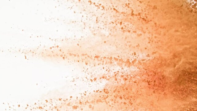 Super Slow Motion Shot of Brown Powder Explosion Isolated on White Background at 1000fps.