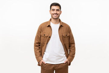 Fototapeta premium Young happy man dressed in casual brown shirt, standing isolated on gray background