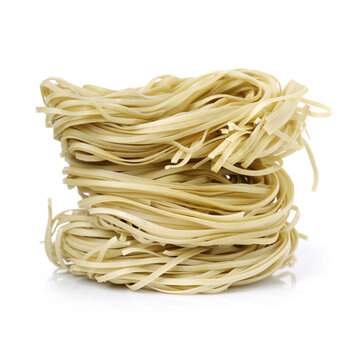 Italian pasta tagliatelle nest on white background