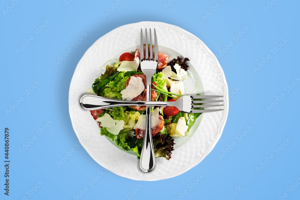 Sticker Steel forks on top of a salad dish. Healthy food concept