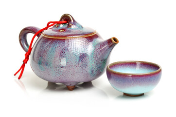 An image of a teapot and teacups on white background