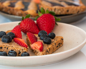 Bread with hazelnut butter, strawberries and blueberries