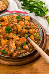 Beef Curry Stew with Potatoes and Carrots on Wooden Background. Selective focus.