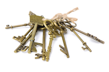 old brass key against a white background