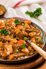 Beef Curry Stew with Potatoes and Carrots on Wooden Background. Selective focus.