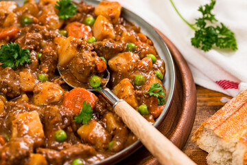 Beef Curry Stew with Potatoes and Carrots on Wooden Background. Selective focus.